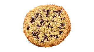 ein rundes Gebäckstück mit dunkelrotem, eingebackenem Obst und Zuckerstreuseln